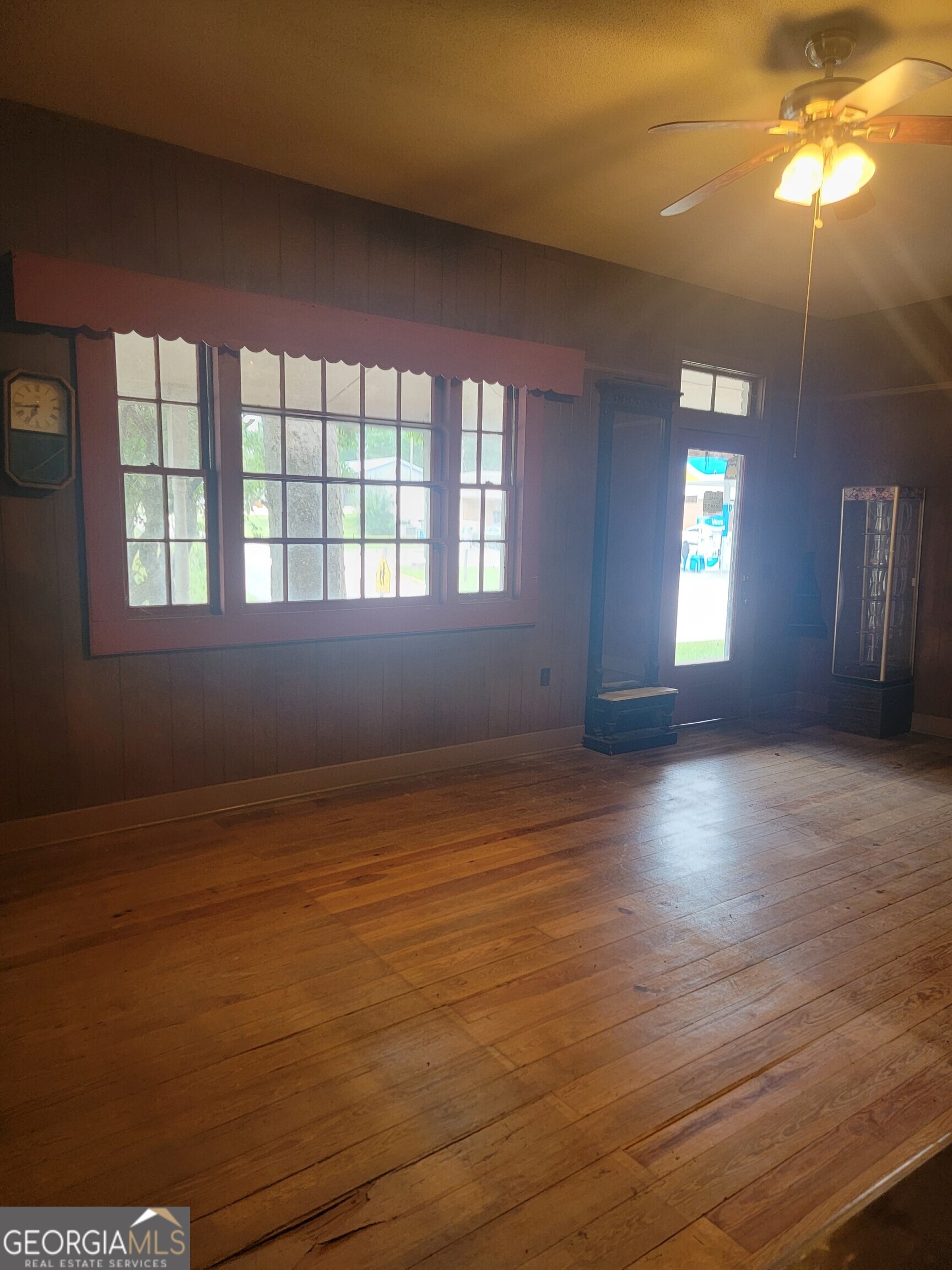 346 South Oliver Street Elberton, GA 30635 - Photo 8 of 52 an empty room with wooden floor and windows