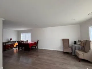 a living room with furniture and kitchen view