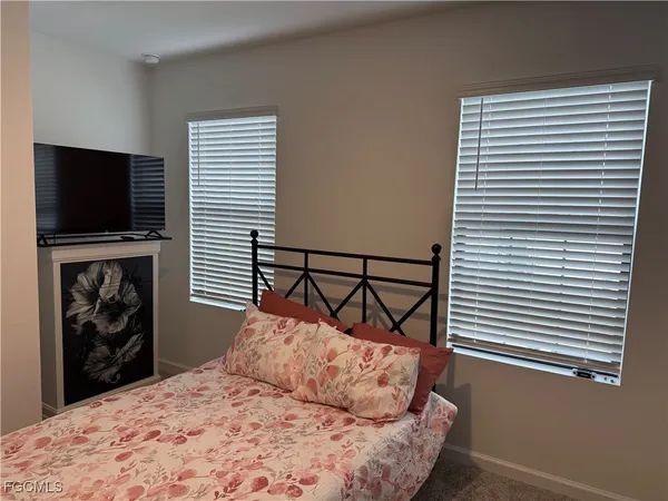 a bedroom with a bed and a table in it