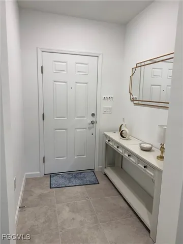 a view of a hallway with a livingroom and furniture