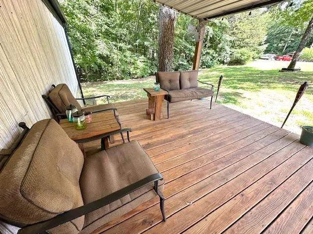 a living room with chairs and a table