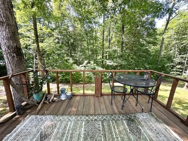a view of balcony with wooden floor and outdoor seating
