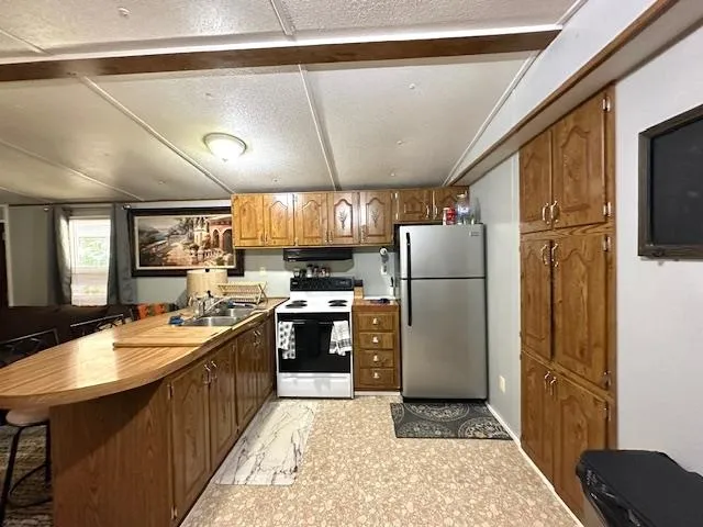 a kitchen with refrigerator and cabinets