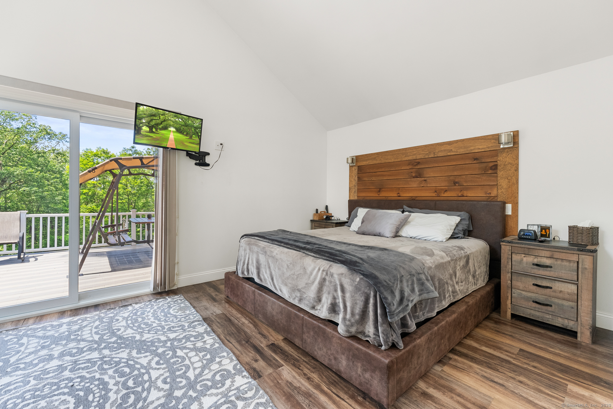 85 Good Hill Road Roxbury, CT 06783 - Photo 11 of 33 a bedroom with a bed a flat tv screen and a dresser