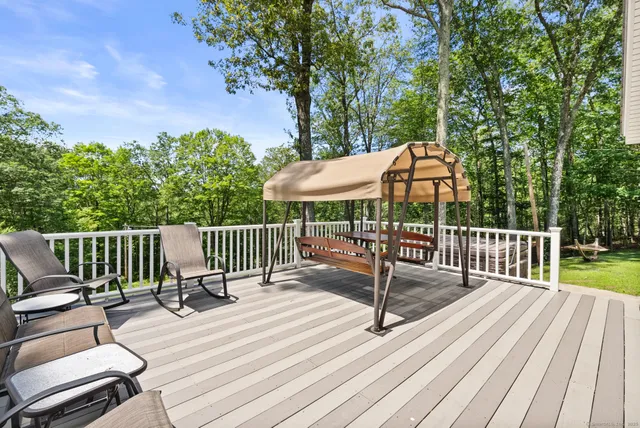 a view of a deck with furniture and wooden deck
