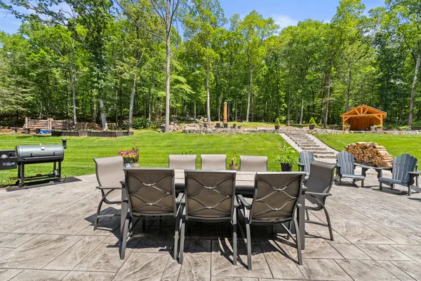 a view of a chairs and table in patio