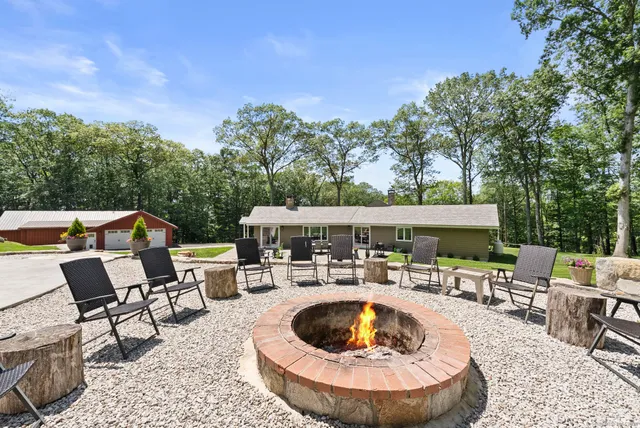 an outdoor space with seating area and barbeque oven
