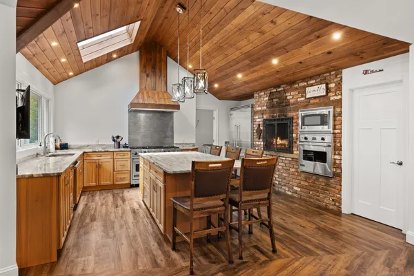 a kitchen with stainless steel appliances granite countertop a stove and a refrigerator