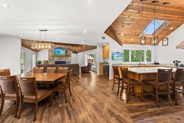 a dining room with a wooden table and chairs