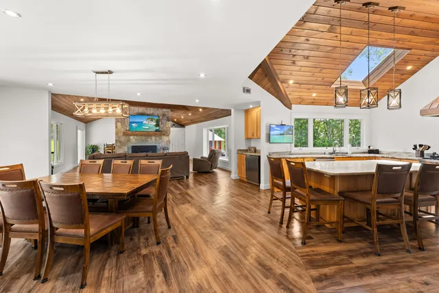 a dining room with a wooden table and chairs