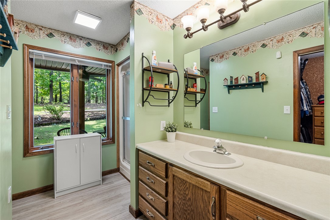 2817 Providence Church Road Anderson, SC 29626 - Photo 16 of 35 A private bathroom with a spacious window offers verdant views and ample vanity storage.