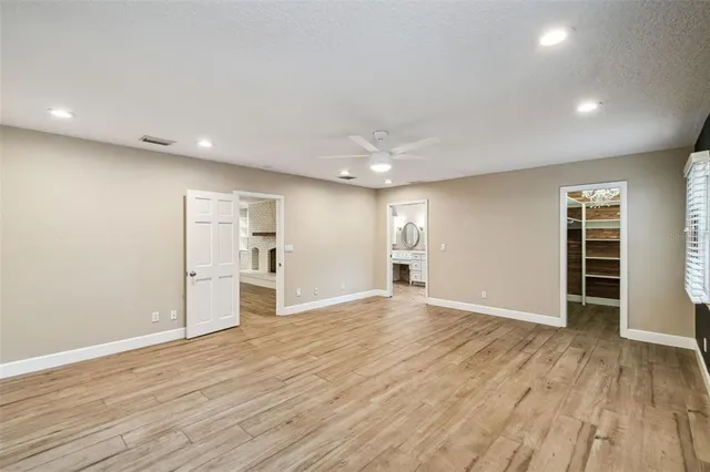 a view of empty room with wooden floor