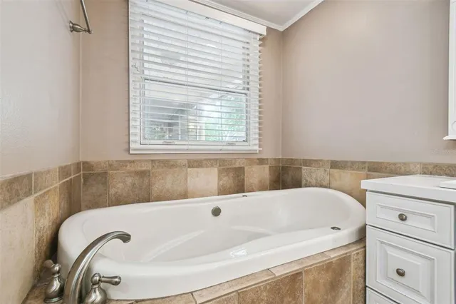 a bathroom with bathtub and window
