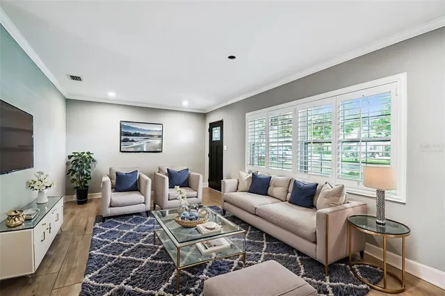 a living room with furniture and a large window