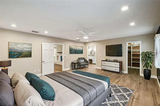 a bedroom with a bed and a flat screen tv