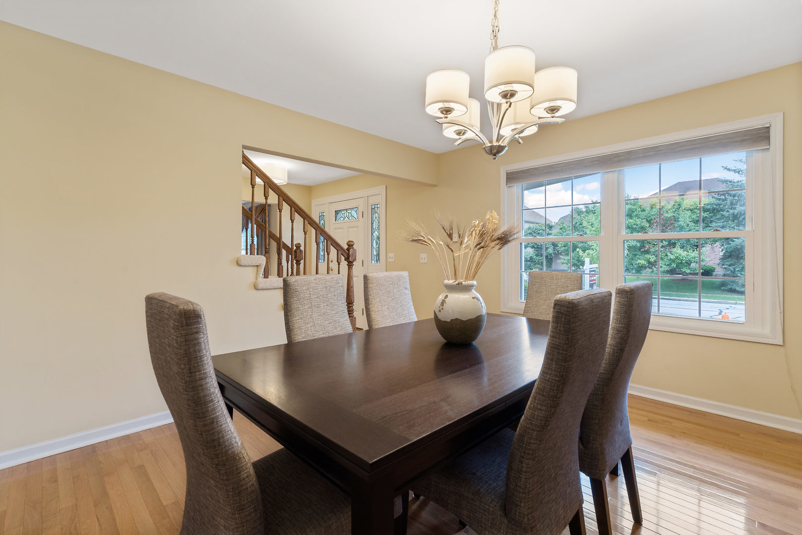 1859 Lisson Road Naperville, IL 60565 - Photo 7 of 32 a view of a dining room with furniture a chandelier and wooden floor