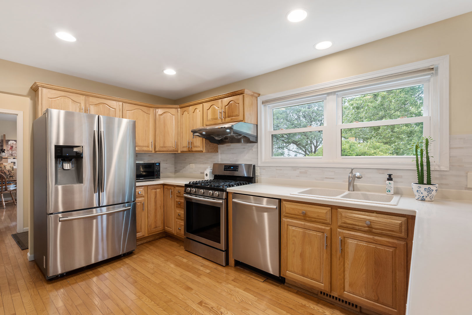1859 Lisson Road Naperville, IL 60565 - Photo 9 of 32 a kitchen with wooden floors and stainless steel appliances