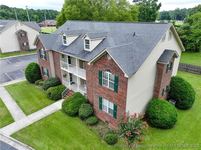 a aerial view of a house with yard and green space