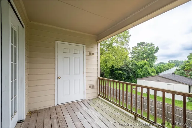 a view of a balcony with wooden floor