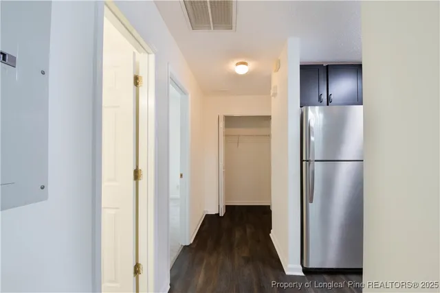 a view of a kitchen from a hallway