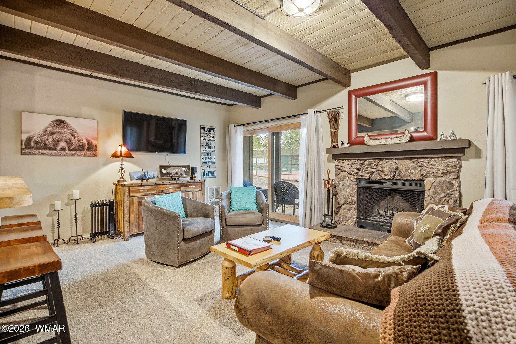 a living room with furniture a flat screen tv and a fireplace