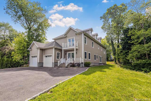 1 Kewanee Road New Rochelle, NY 10804 - Photo 29 of 36 a front view of a house with a yard table and chairs