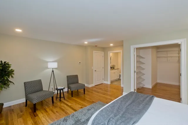 a bathroom with a granite countertop sink and a toilet