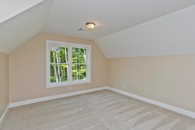 a bathroom with a granite countertop toilet a sink a mirror and a window