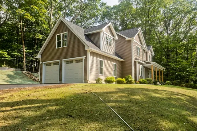 a front view of a house with a garden