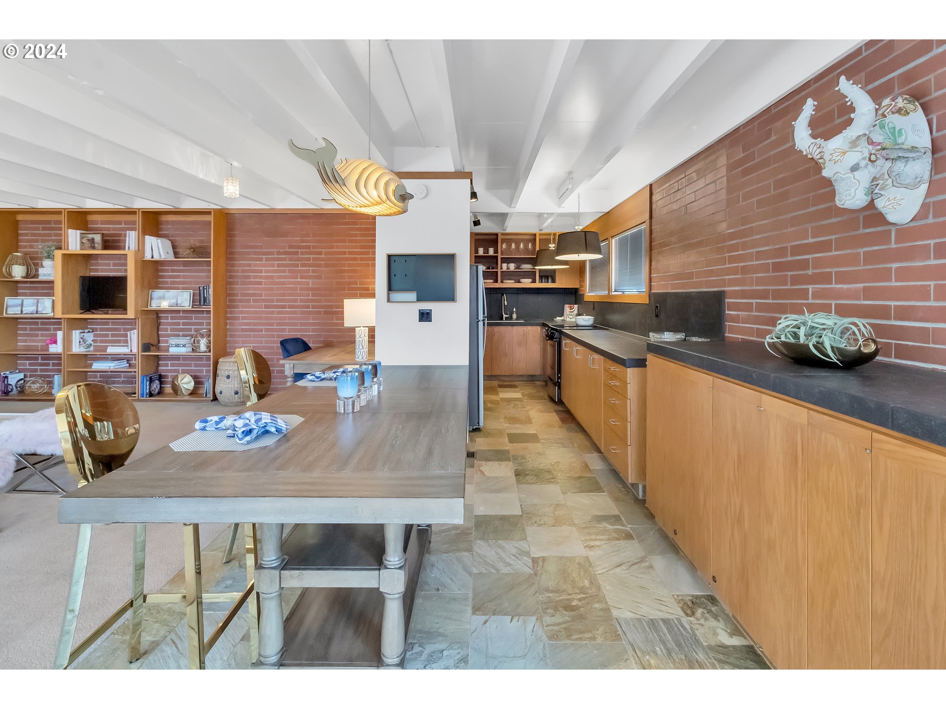 106 High Street Eugene, OR 97401 - Photo 18 of 46 a kitchen with stainless steel appliances kitchen island granite countertop a table chairs in it and wooden floor