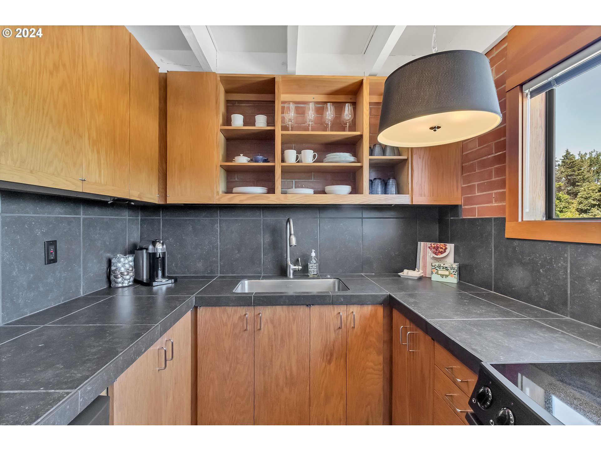 106 High Street Eugene, OR 97401 - Photo 19 of 46 a kitchen with stainless steel appliances granite countertop a sink a stove and a microwave