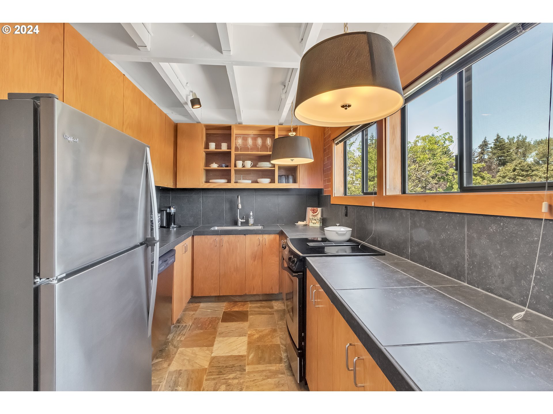 106 High Street Eugene, OR 97401 - Photo 20 of 46 a kitchen with stainless steel appliances granite countertop a sink a refrigerator and a stove