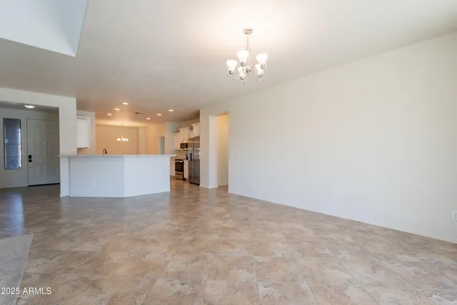 a kitchen with stainless steel appliances granite countertop a sink stove microwave and refrigerator