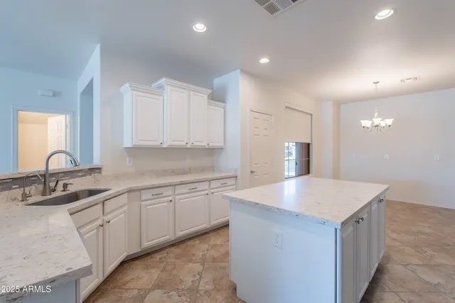 a kitchen with stainless steel appliances granite countertop a sink and a stove