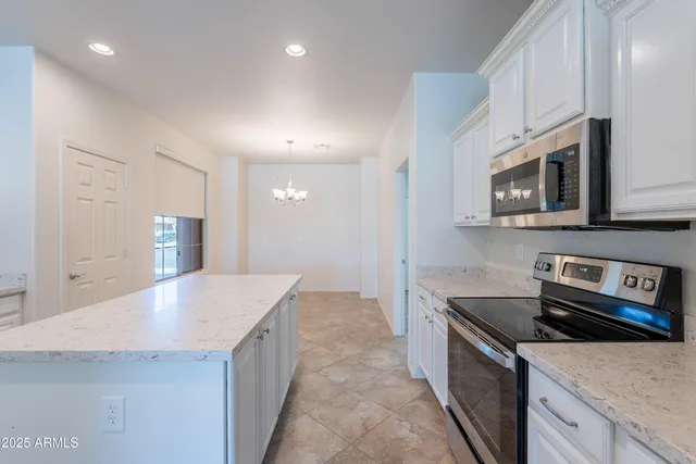 a kitchen with a stove a sink and a refrigerator