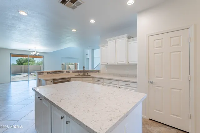 a view of a chandelier in big room and a bathroom