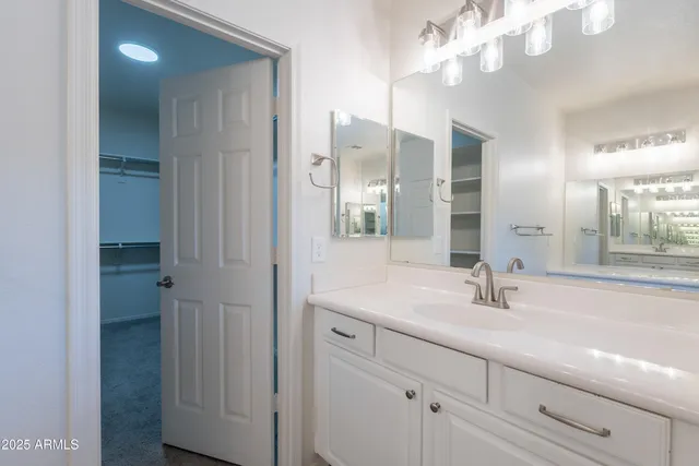 a bathroom with a sink and mirror