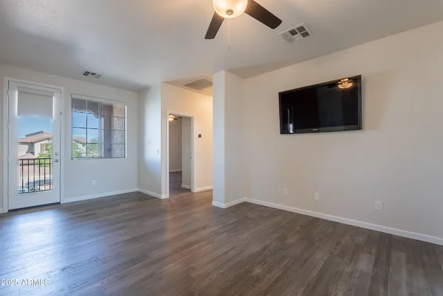wooden floor in an empty room with a window