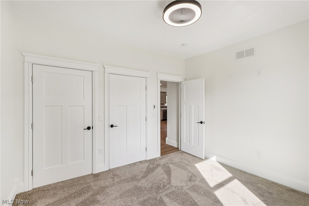 6535 North Ridge Road West Geneva, OH 44041 - Photo 25 of 48 Unfurnished bedroom with carpet and baseboards