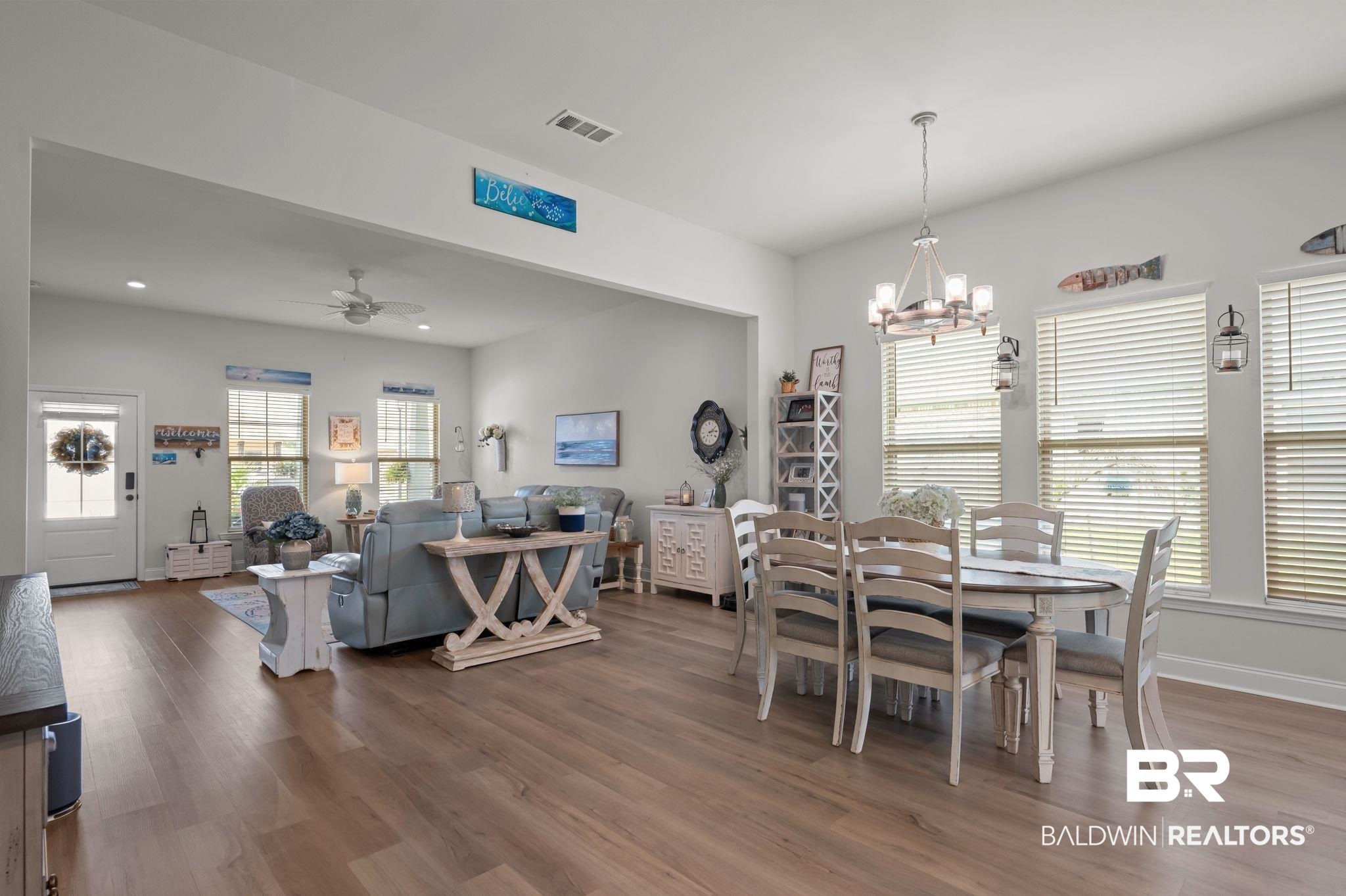 1165 Stella Road Foley, AL 36535 - Photo 9 of 42 Dining space with wood finished floors, a chandelier, a ceiling fan, and baseboards
