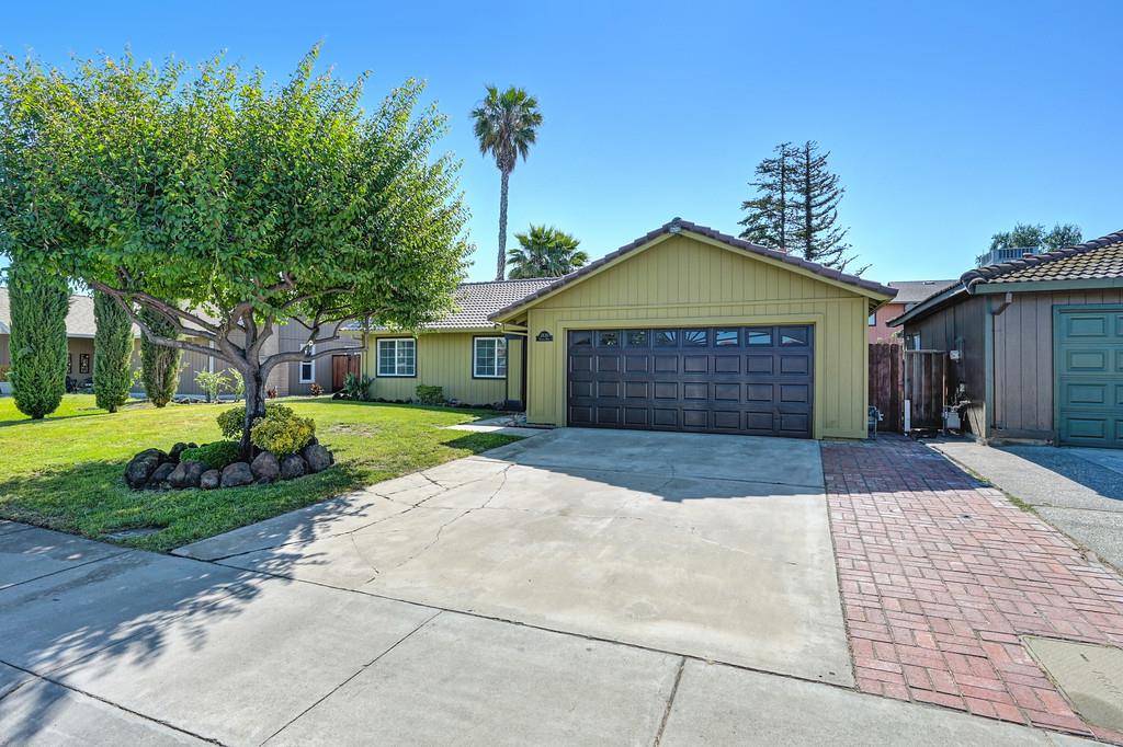 a front view of a house with a yard and garage