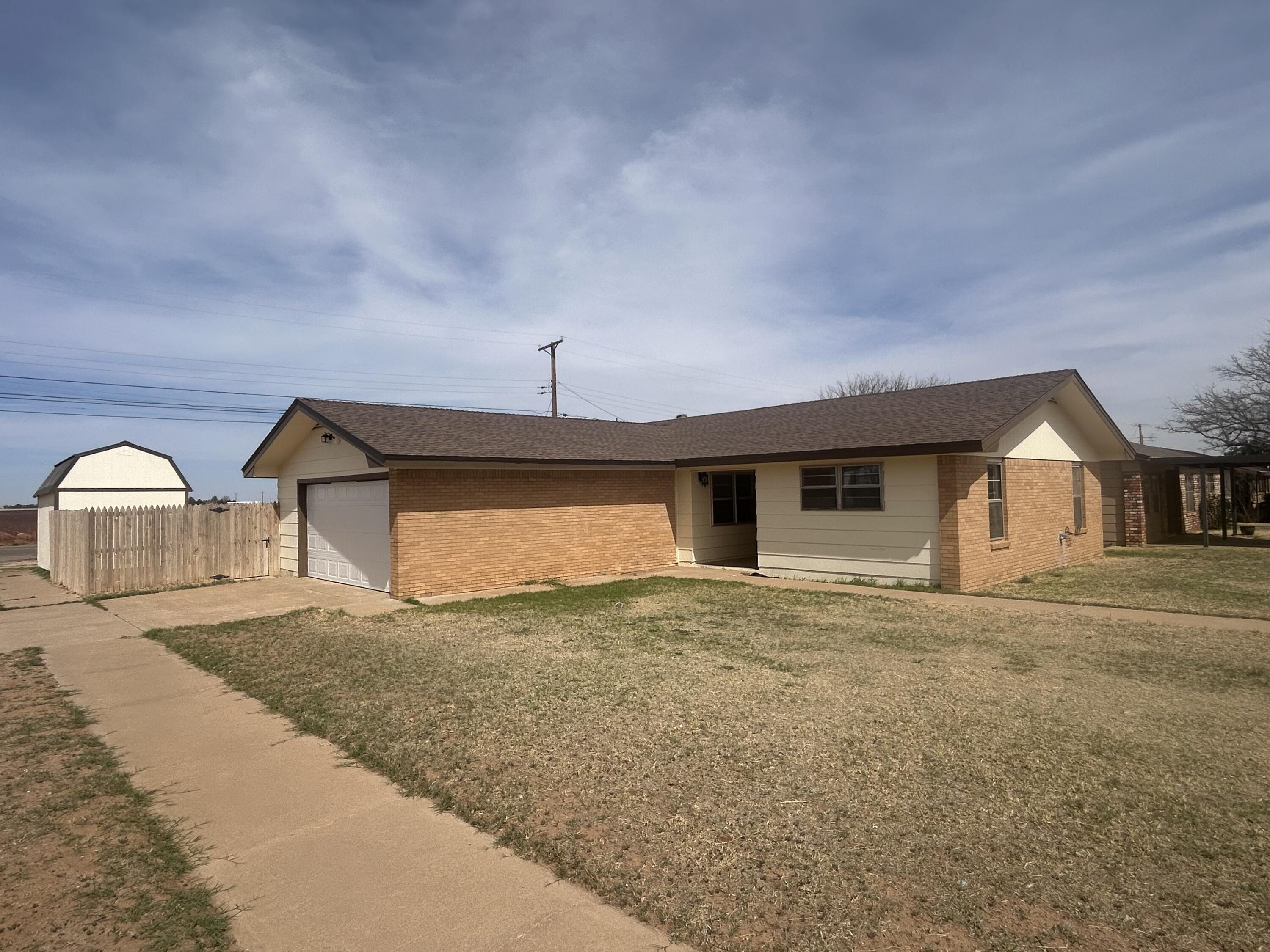 111 Bobby Street Levelland, TX 79336 - Photo 1 of 25 a view of a house with a yard and garage