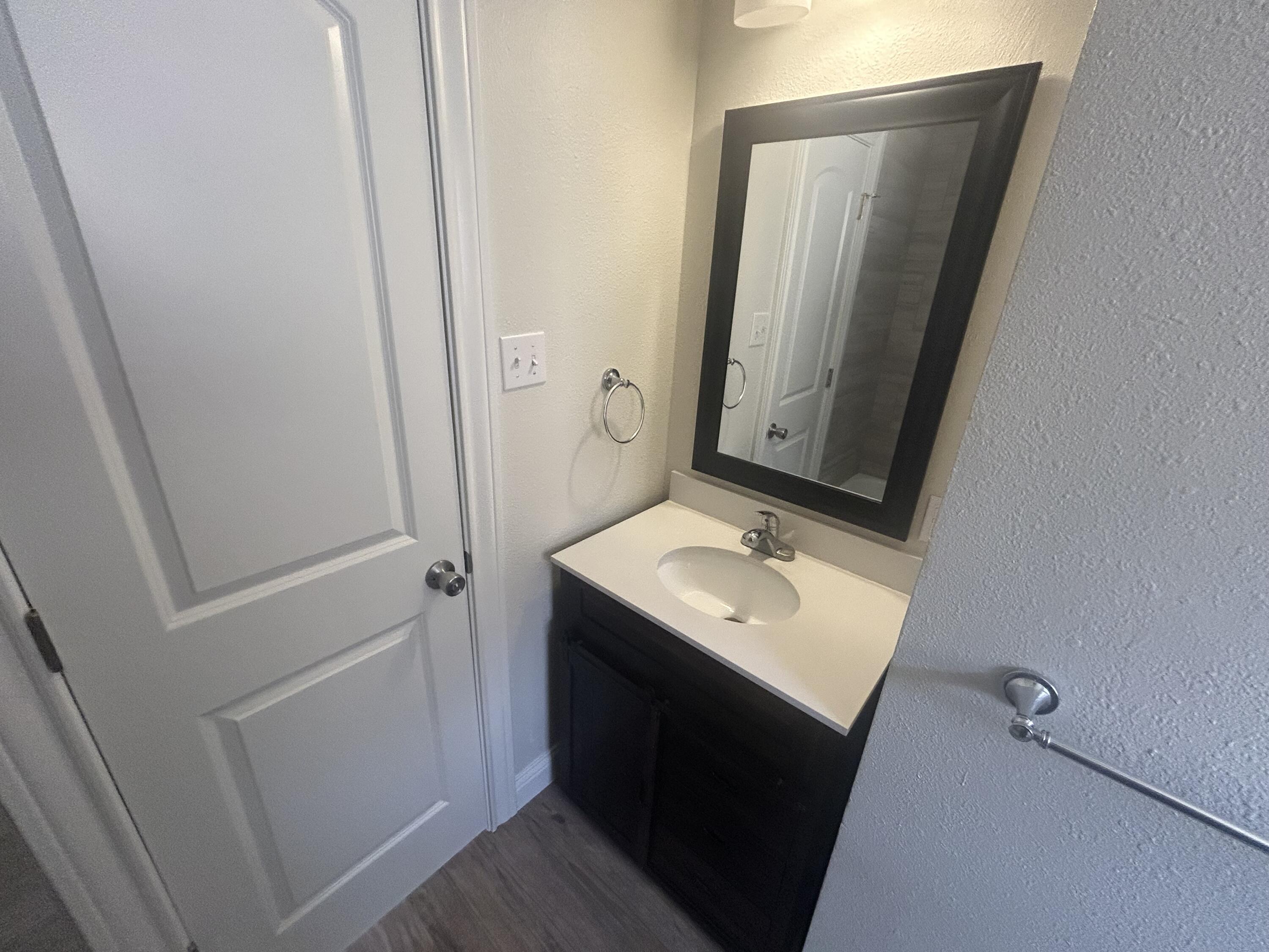 111 Bobby Street Levelland, TX 79336 - Photo 17 of 25 a bathroom with a sink toilet and mirror