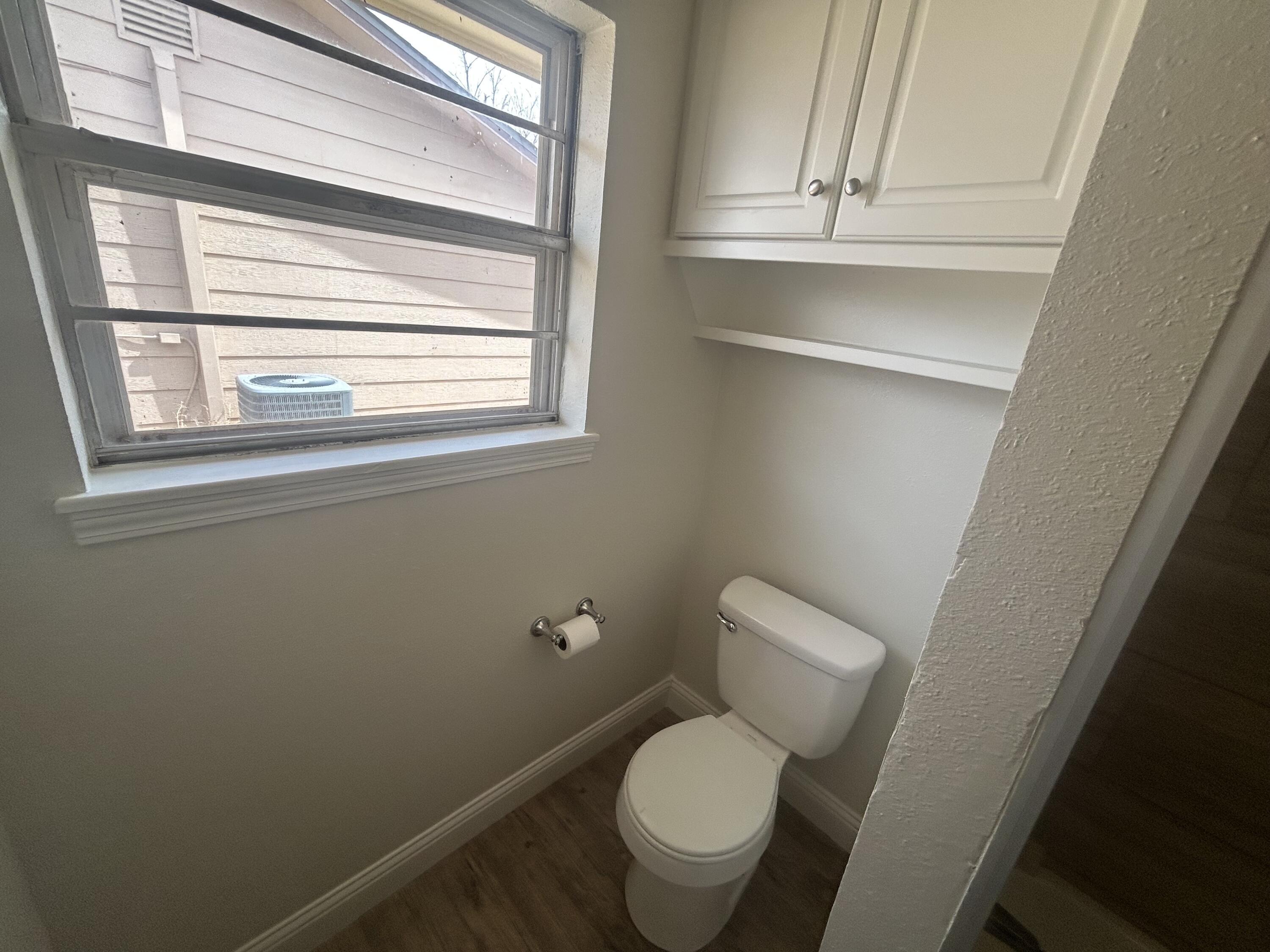 111 Bobby Street Levelland, TX 79336 - Photo 19 of 25 a white toilet sitting next to a window