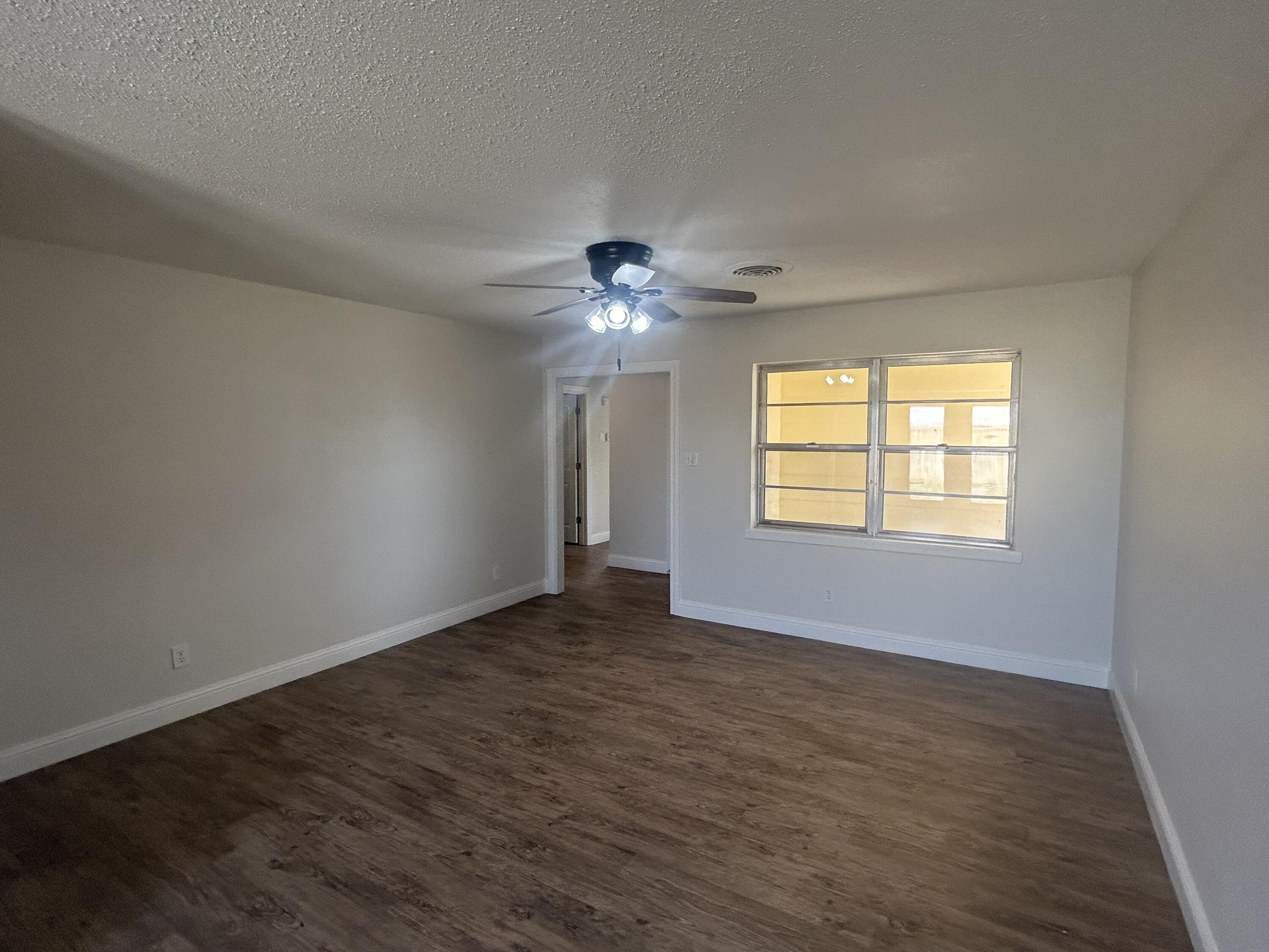 111 Bobby Street Levelland, TX 79336 - Photo 3 of 25 a view of an empty room with a window