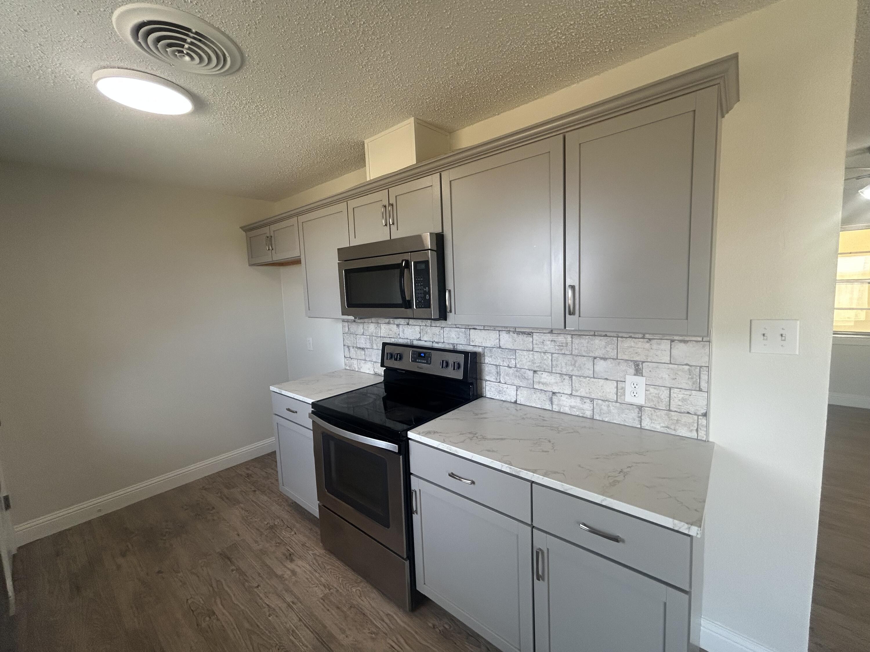 111 Bobby Street Levelland, TX 79336 - Photo 6 of 25 a kitchen with a sink and a microwave