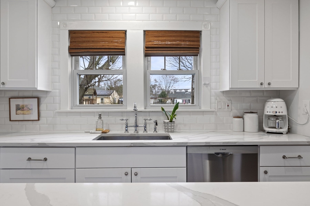6 Pilgrim Road Marblehead, MA 01945 - Photo 11 of 42 a kitchen with stainless steel appliances white cabinets and a window