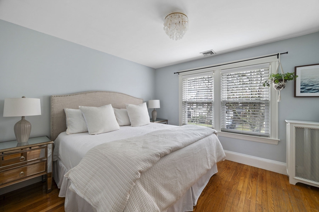 6 Pilgrim Road Marblehead, MA 01945 - Photo 21 of 42 a bedroom with a large bed and a chandelier