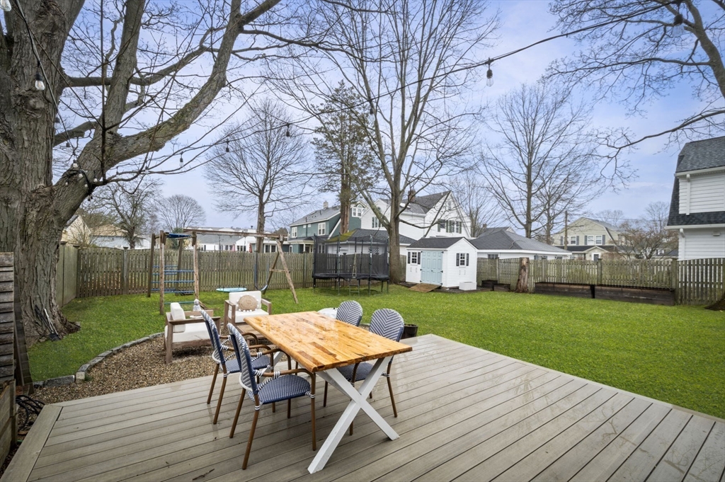 6 Pilgrim Road Marblehead, MA 01945 - Photo 35 of 42 a view of a patio with table and chairs and wooden fence