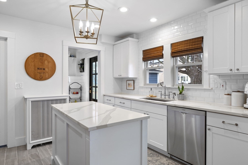 6 Pilgrim Road Marblehead, MA 01945 - Photo 8 of 42 a kitchen with a sink a refrigerator and a clock